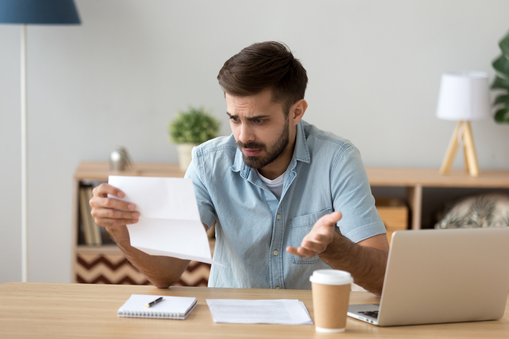 Confused,Frustrated,Young,Man,Holding,Mail,Letter,Reading,Shocking,Unexpected